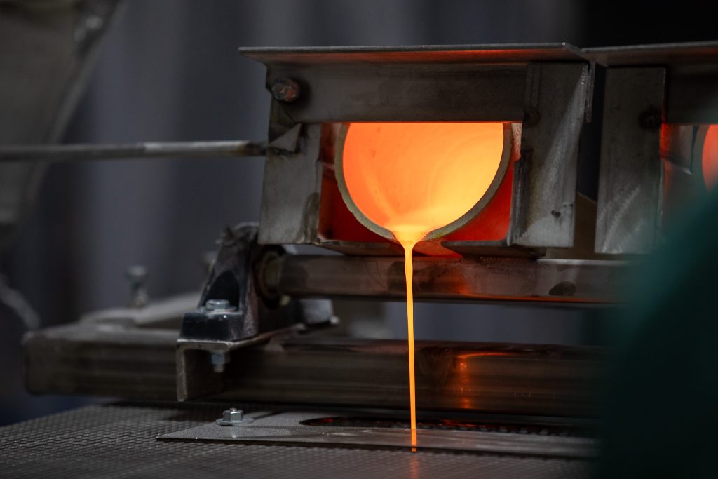 Molten glass being poured from a crucible